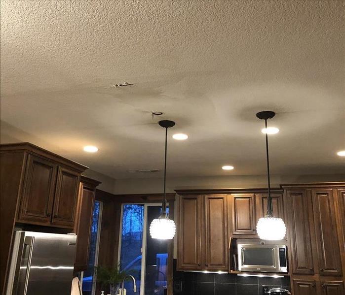 Water damaged ceiling from upstairs bathroom.