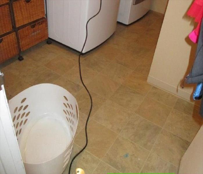 A flooded utility room in a basement.