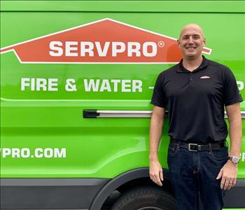 male standing in front of a SERVPRO vehicle.