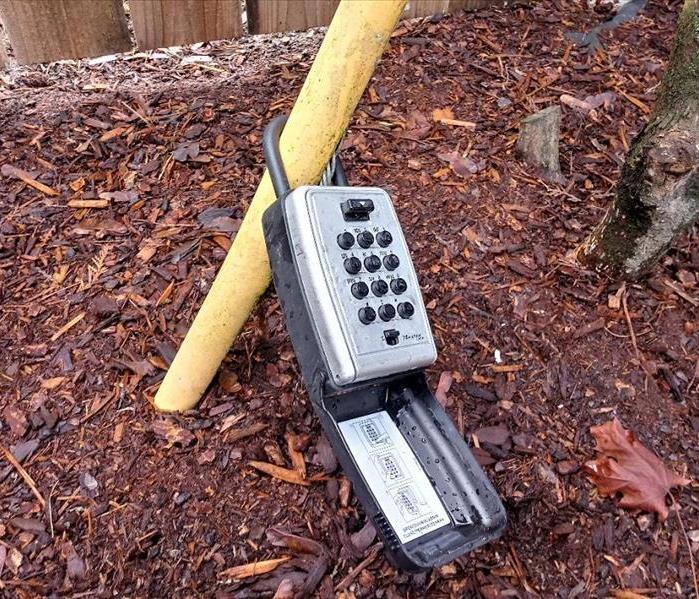 A coded lock box at a fire damaged home.